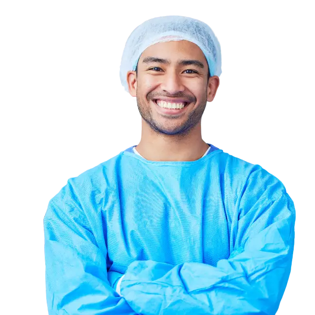 A smiling male surgeon wearing a blue scrub suit, exuding professionalism and care in a medical environment.